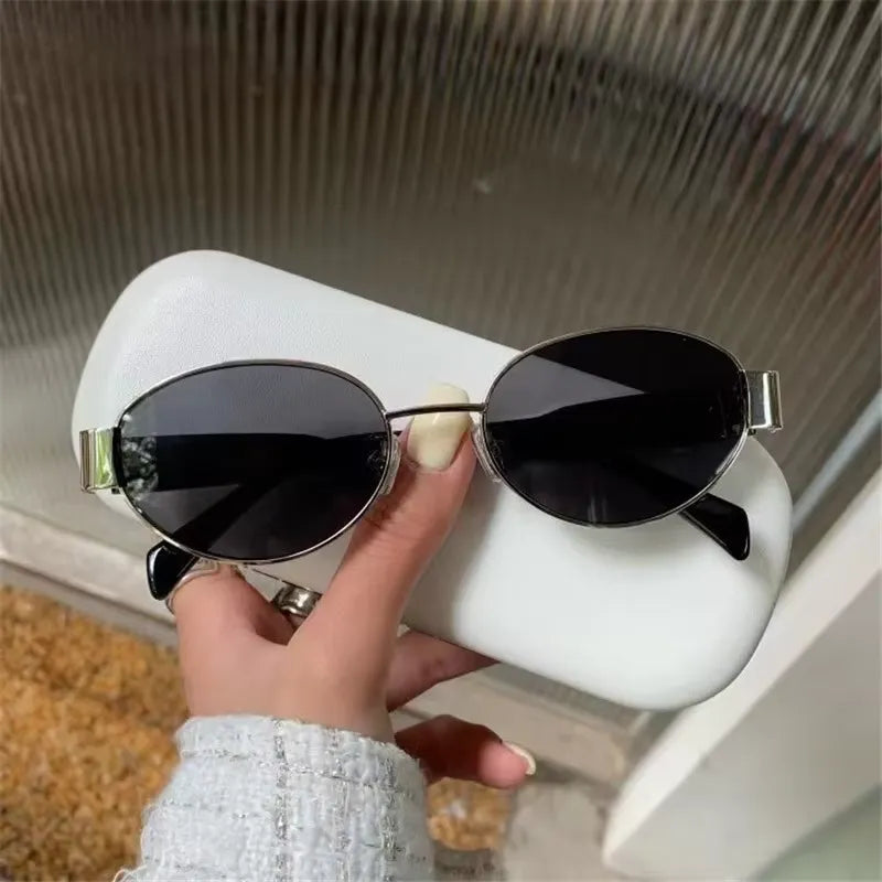 Chic oval metal sunglasses with sleek frame and tinted lenses, stylish accessory by StorePilot.