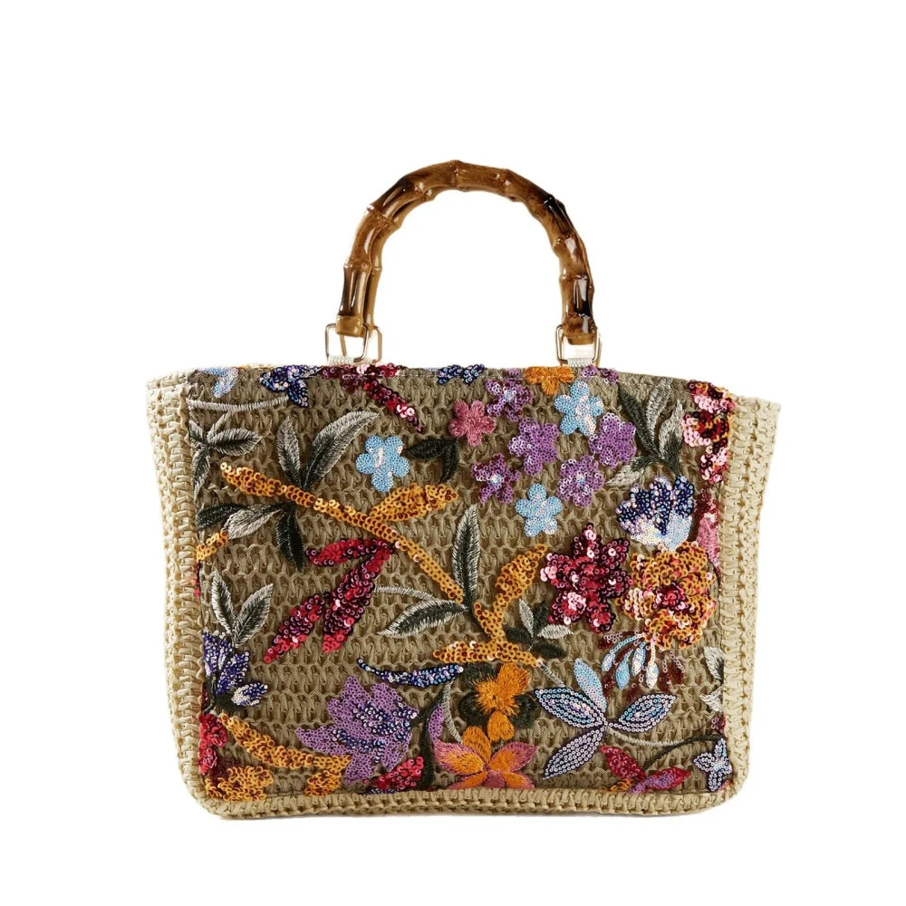 Bamboo handle straw tote bag from TheChicRoom with woven design and spacious interior for casual outings.