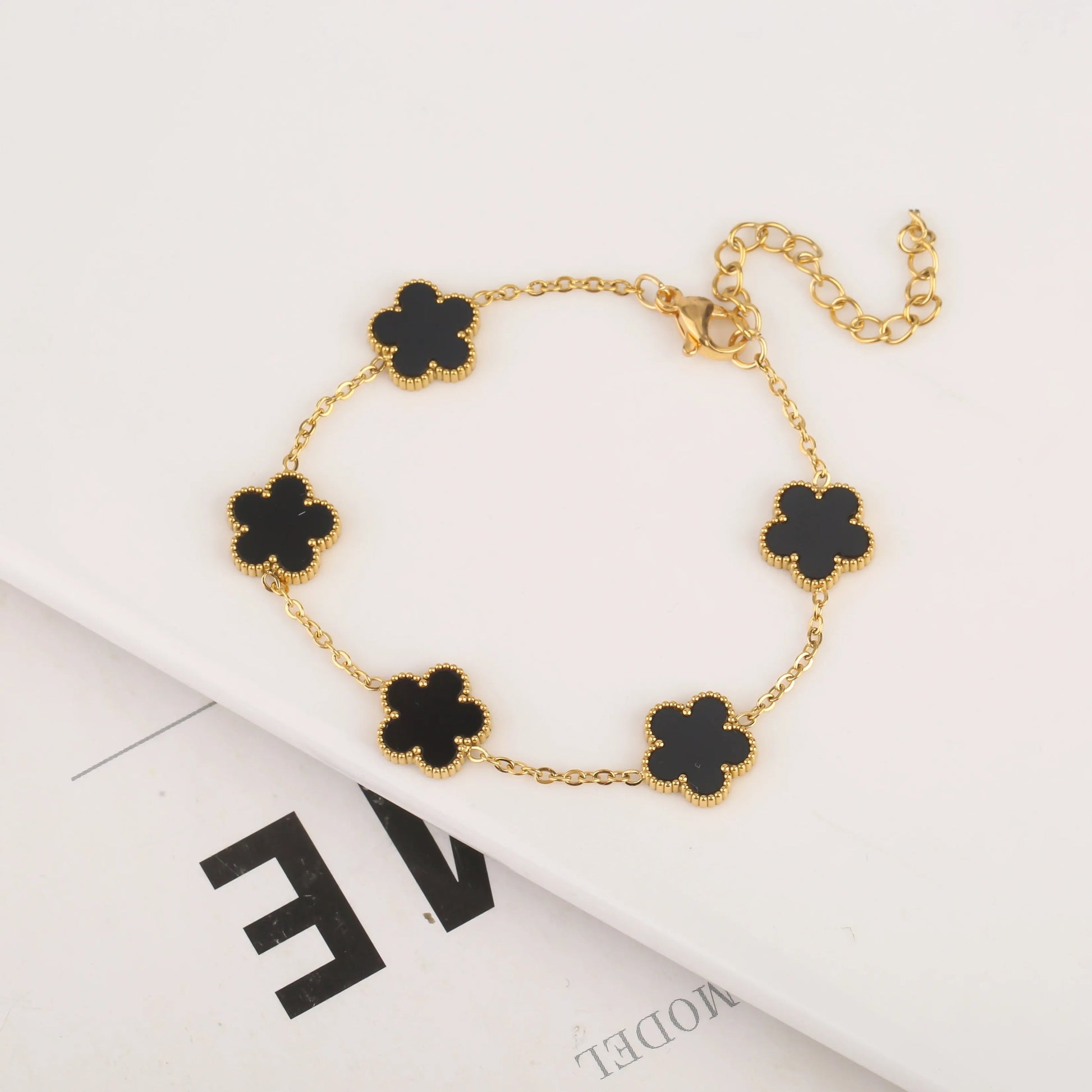 Silver five-leaf bracelet with delicate leaf charms, elegant jewelry piece from StorePilot displayed on a neutral background.