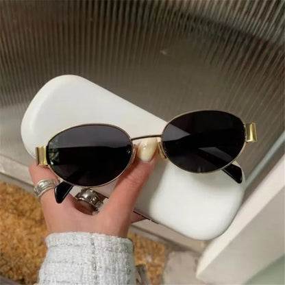 Chic oval metal sunglasses with sleek frame and tinted lenses, stylish accessory by StorePilot.