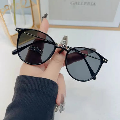 Retro round sunglasses with chic design, featuring dark lenses and thin metal frames, by StorePilot.