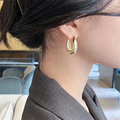 Vintage hoop drop earrings with a classic design, featuring gold-tone metal and elegant dangling hoop style.