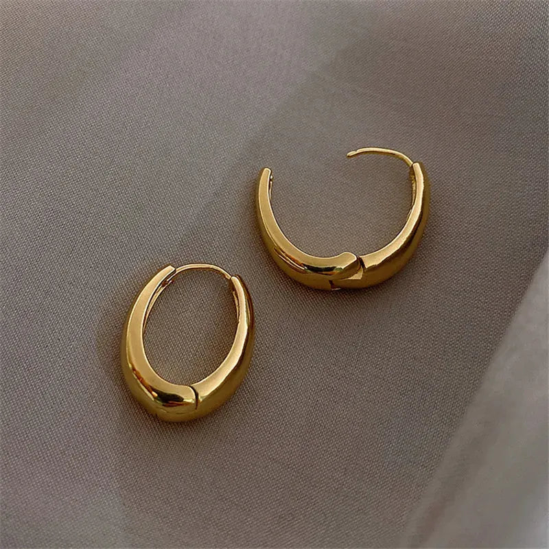Vintage hoop drop earrings with a classic design, featuring a polished metal finish and elegant hanging style.