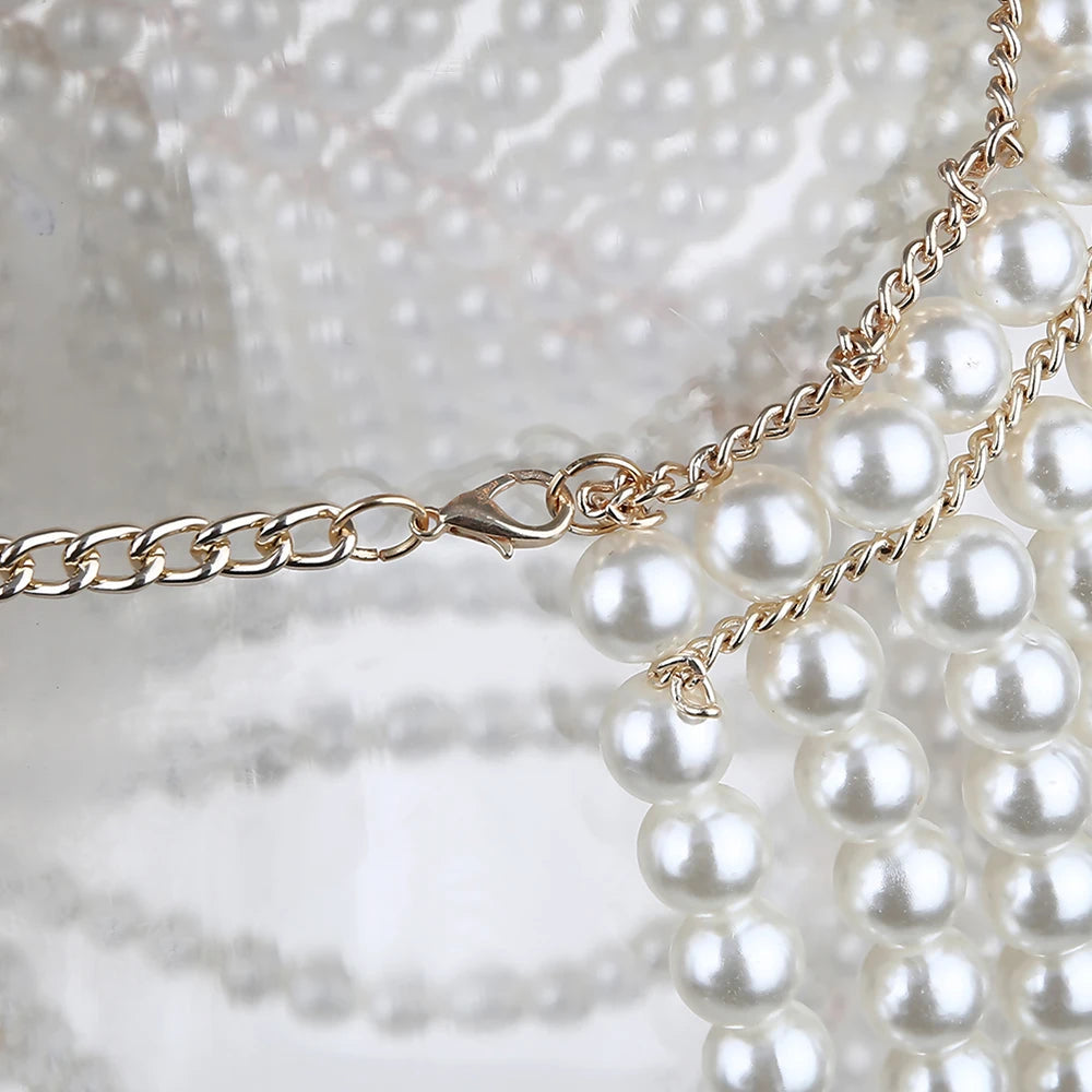 Pearl body chain jewelry top featuring a delicate chain with pearl accents, designed to be worn as stylish body jewelry.