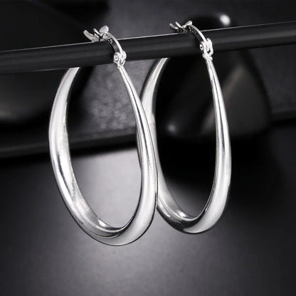 Elegant silver hoop earrings with a polished finish, featuring a classic circular design, perfect for stylish accessories.