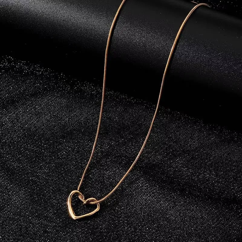 Heart pendant necklace featuring a delicate silver chain and a polished heart-shaped pendant, stylish jewelry for women.