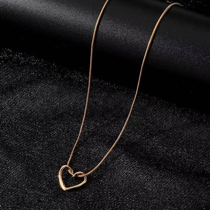Heart pendant necklace featuring a delicate silver chain and a polished heart-shaped pendant, stylish jewelry for women.
