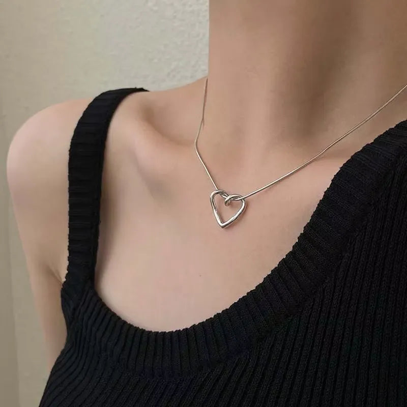 Elegant silver heart pendant necklace featuring a delicate chain, stylish jewelry piece by StorePilot.