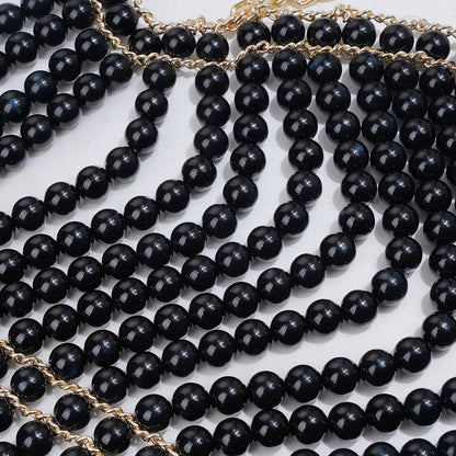 Elegant pearl body chain jewelry top featuring delicate pearls and sleek design, perfect for stylish summer fashion.