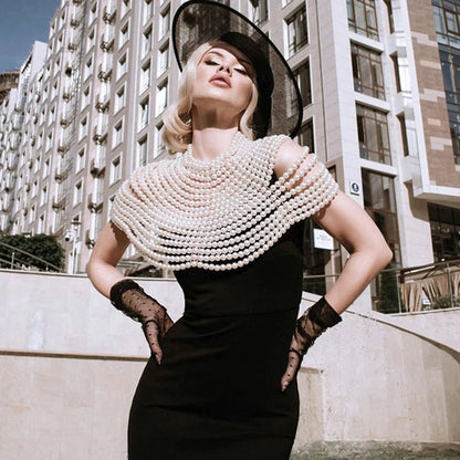 Pearl body chain jewelry top featuring a delicate design with pearl accents, perfect for stylish summer or festival outfits.