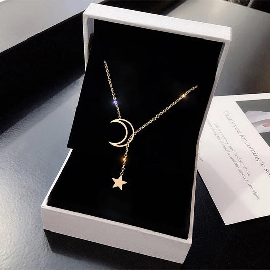 Moon and star choker necklace featuring a sleek black cord and silver moon and star charms, stylish jewelry accessory.