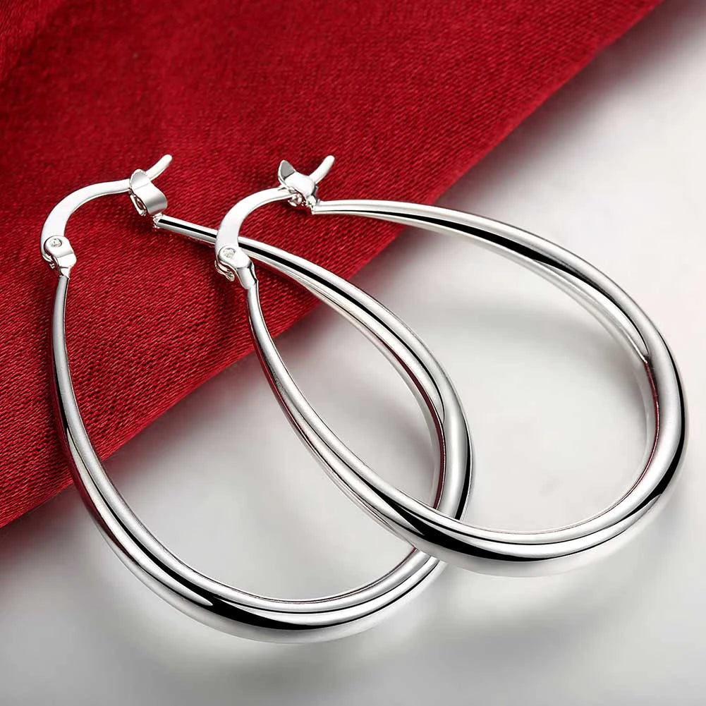 Elegant silver hoop earrings with a polished finish, showcasing a classic and stylish accessory for everyday wear.