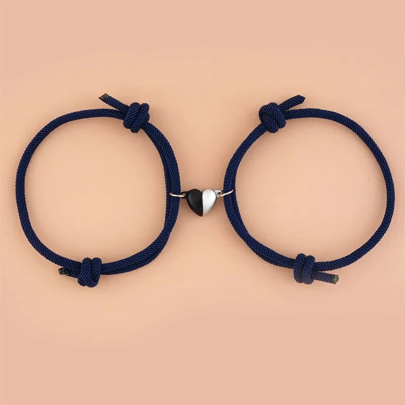 Pair of magnetic love bracelets for couples with intertwined designs, featuring silver-tone metal and heart-shaped accents.