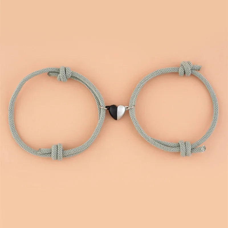 Magnetic love bracelets for couples by StorePilot, featuring matching black and silver band designs on a white background.