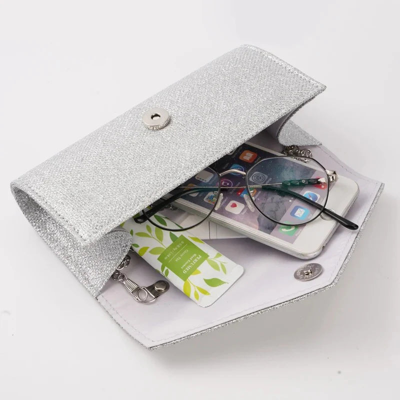 Glam Silver Evening Clutch by StorePilot featuring a sleek, metallic design with a fold-over flap and elegant chain strap.