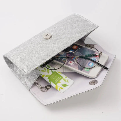 Glam Silver Evening Clutch by StorePilot featuring a sleek, metallic design with a fold-over flap and elegant chain strap.