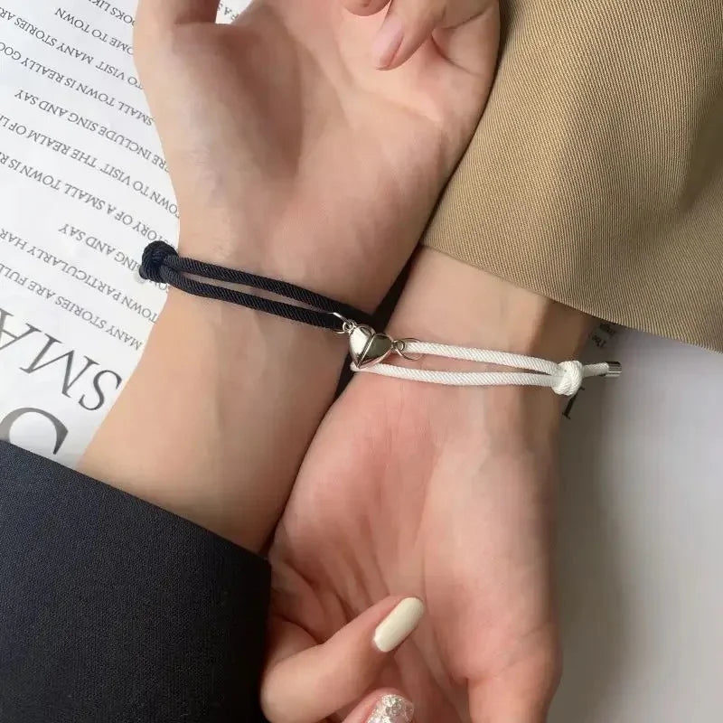 Magnetic love bracelets for couples from StorePilot, featuring matching silver-tone bands with heart-shaped magnetic clasps.