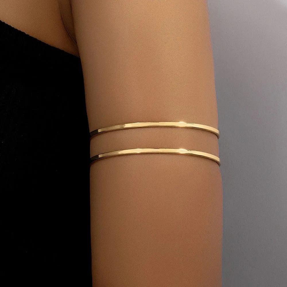 Gold Glam adjustable arm cuff bracelet with intricate design, featuring a shiny gold finish and elegant style.