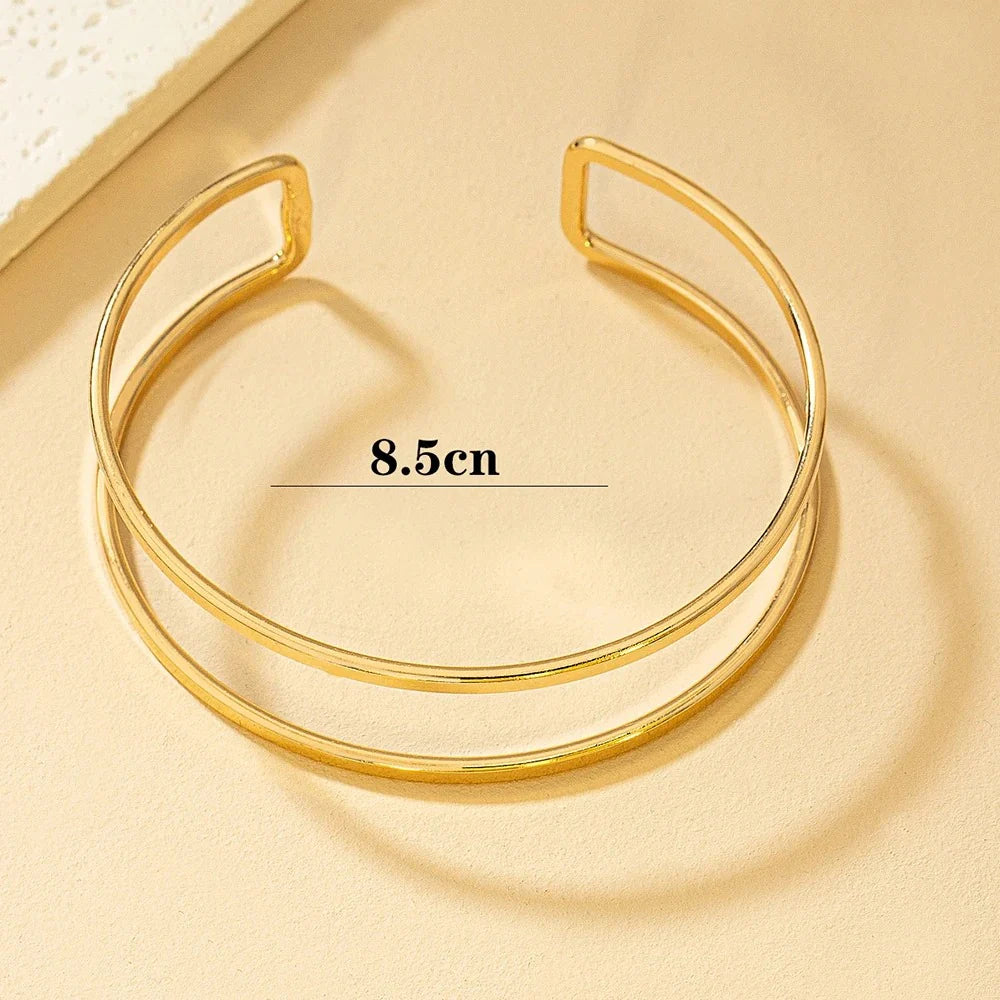 Gold Glam adjustable arm cuff by StorePilot featuring a sleek, elegant design and a shiny gold finish.