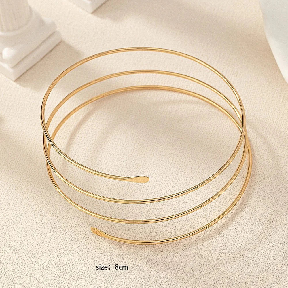 Gold Glam adjustable arm cuff by StorePilot featuring sleek design and elegant gold finish on a model's arm.