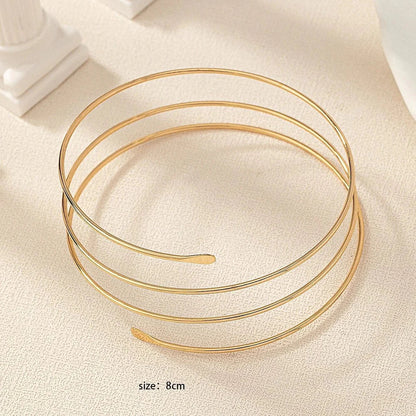 Gold Glam adjustable arm cuff by StorePilot featuring sleek design and elegant gold finish on a model's arm.