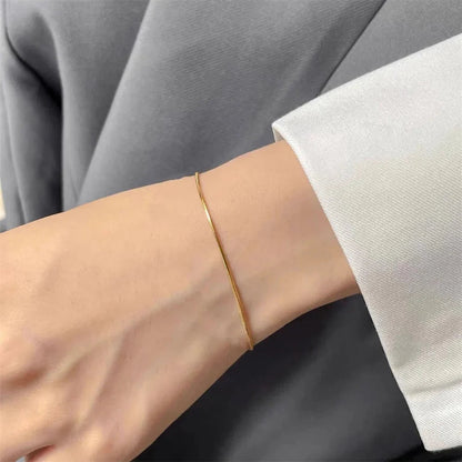 Gold snake chain bracelet from StorePilot featuring a sleek, twisted design with a polished finish.