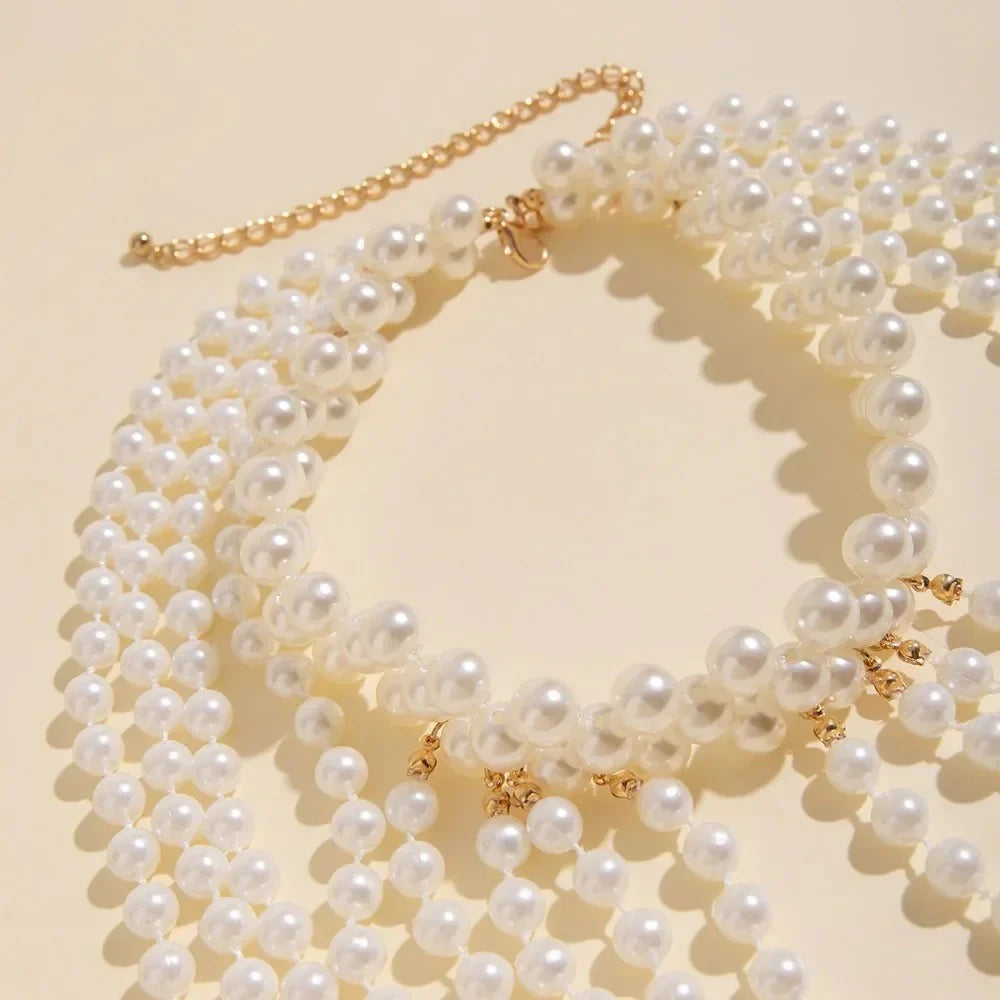 Glam Pearl Body Chain Necklace featuring multiple pearl strands and delicate chain design, perfect for stylish body jewelry.