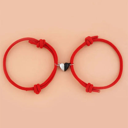 Magnetic love bracelets for couples by StorePilot, featuring intertwined silver-toned bands with heart-shaped charms.