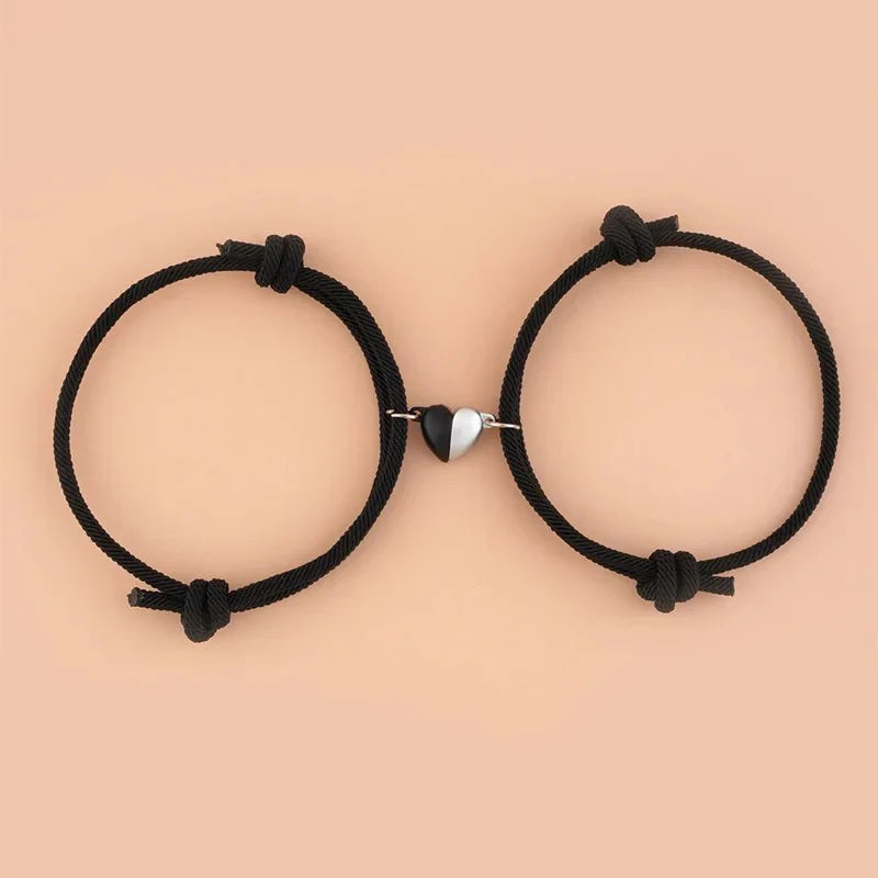 Magnetic love bracelets for couples, stylish silver-tone jewelry with heart-shaped charms, displayed on a white background.